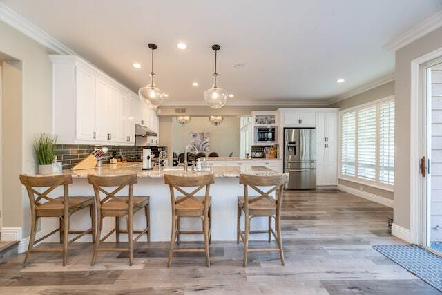 kitchen island with 4 stools on light wood floor